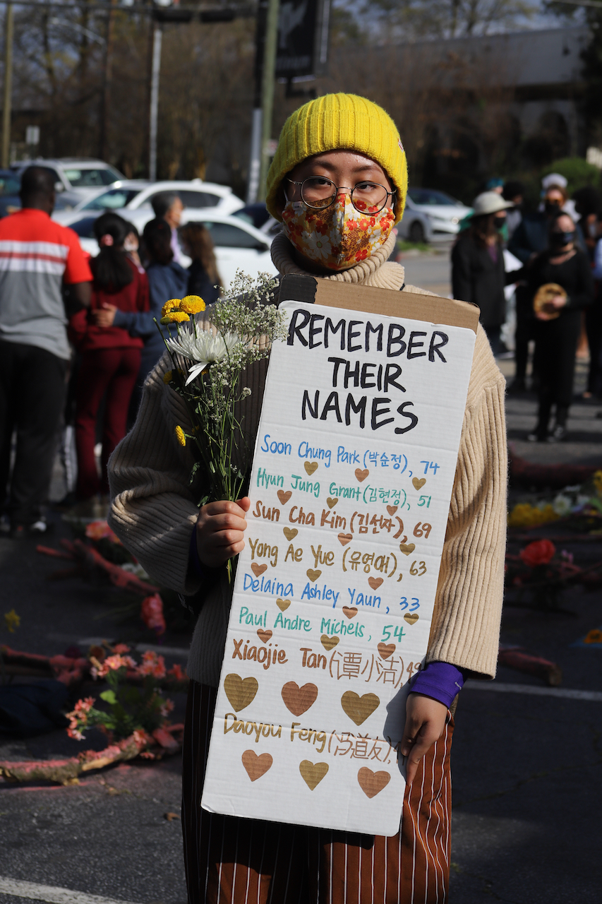 A vigil attendee honored the victims of the anti-Asian spa shootings in Atlanta by remembering their names on March 21, 2021. Photo by Jerel Cooper / Shutterstock.