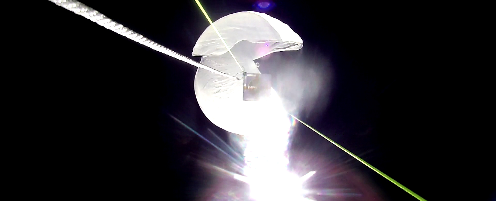 The balloon began to parachute down at maximum altitude.