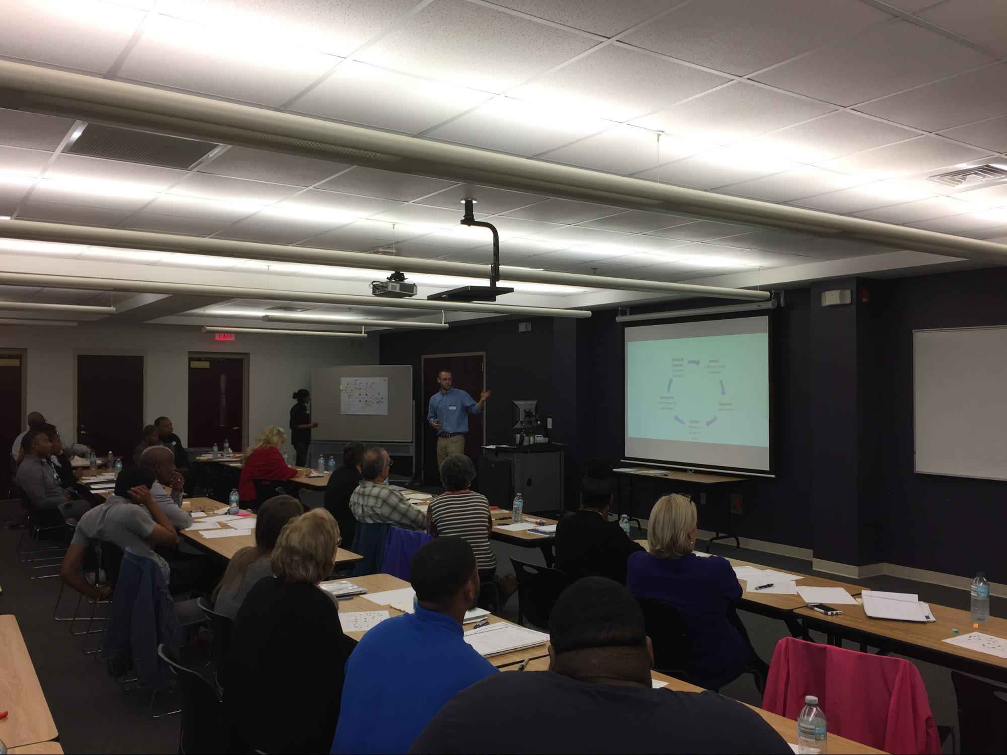 Saeugling sharing context with the local “design team.” Over 45 community members showed up to the most recent meeting to give their input on the rough draft of the systems map.