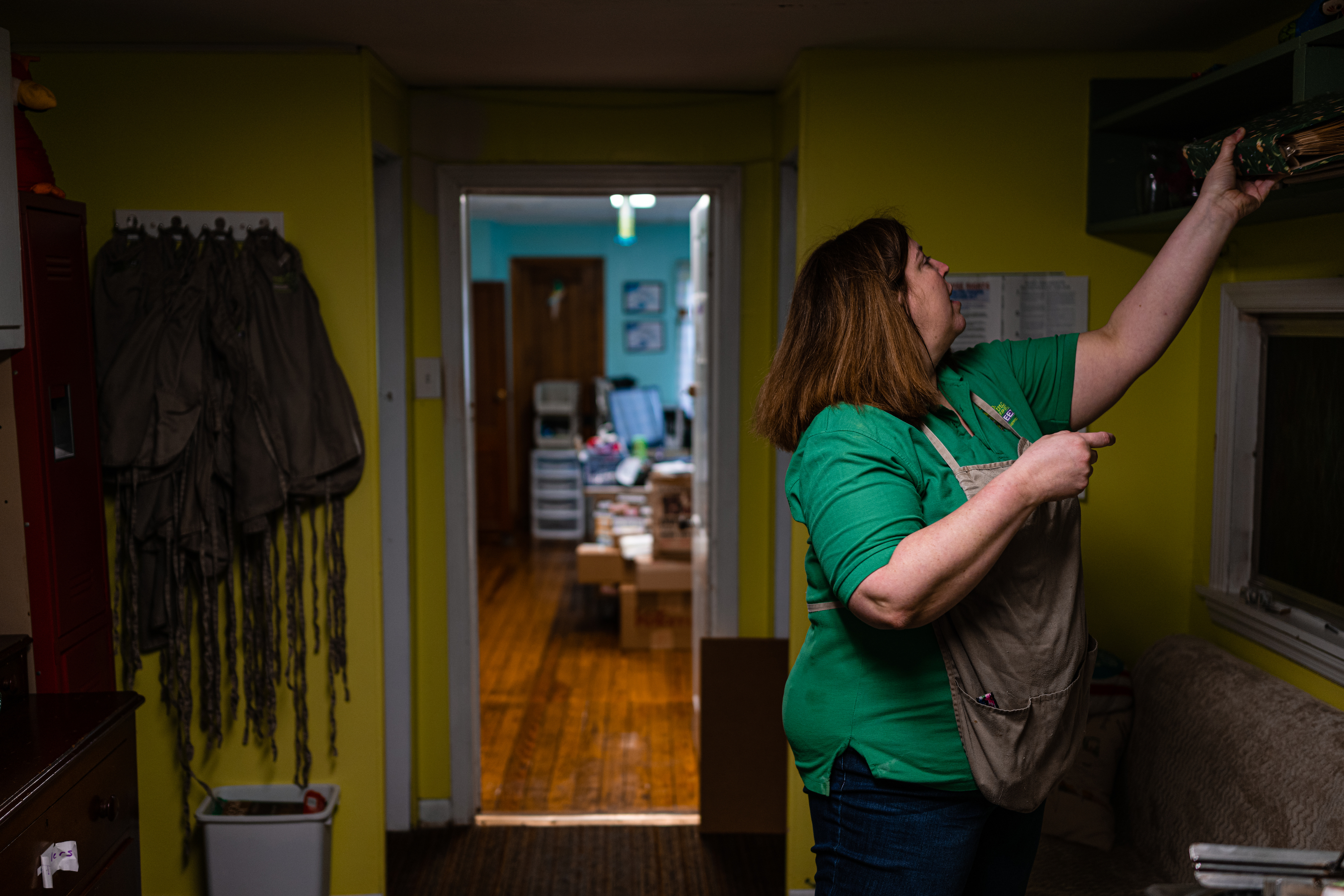 Cara Rothrock reaches for a photo album at Polly’s Freeze in Georgetown, Indiana