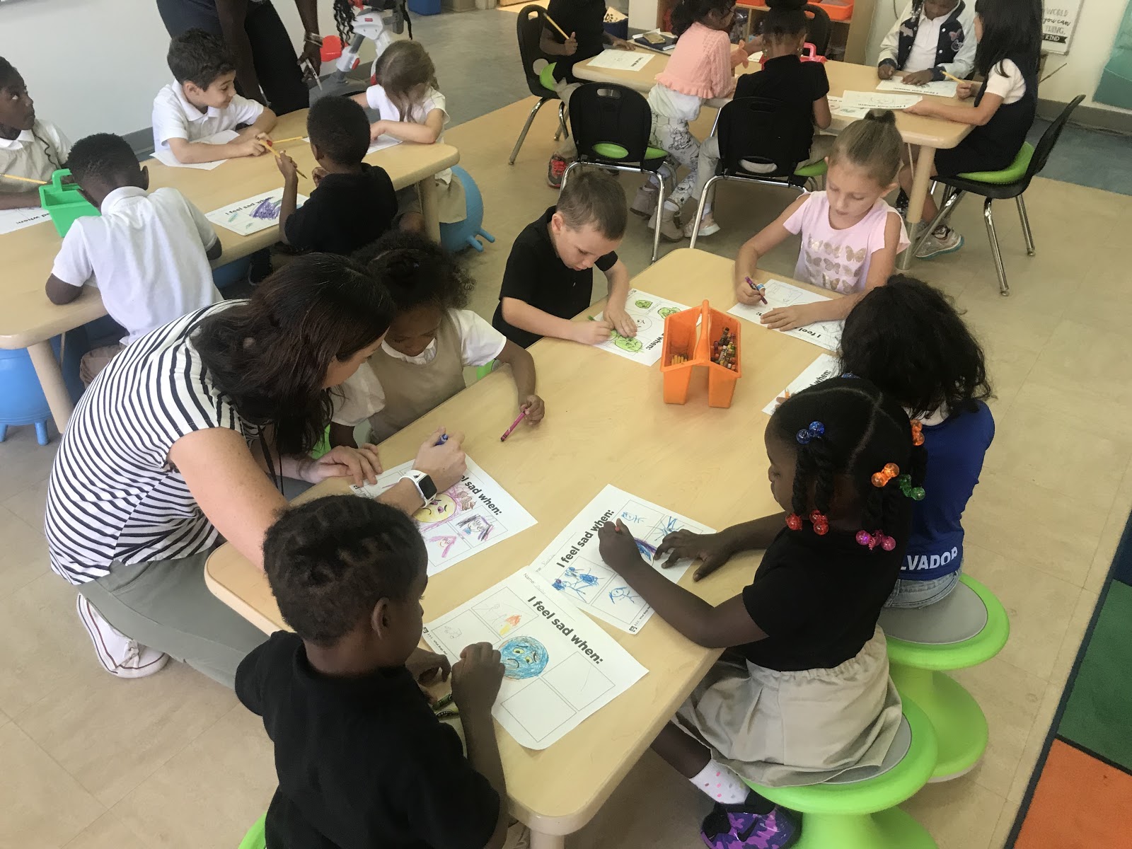 Kindergarteners at Langley illustrating a time in their lives when they remember feeling sad. (Emily Tate / EdSurge)