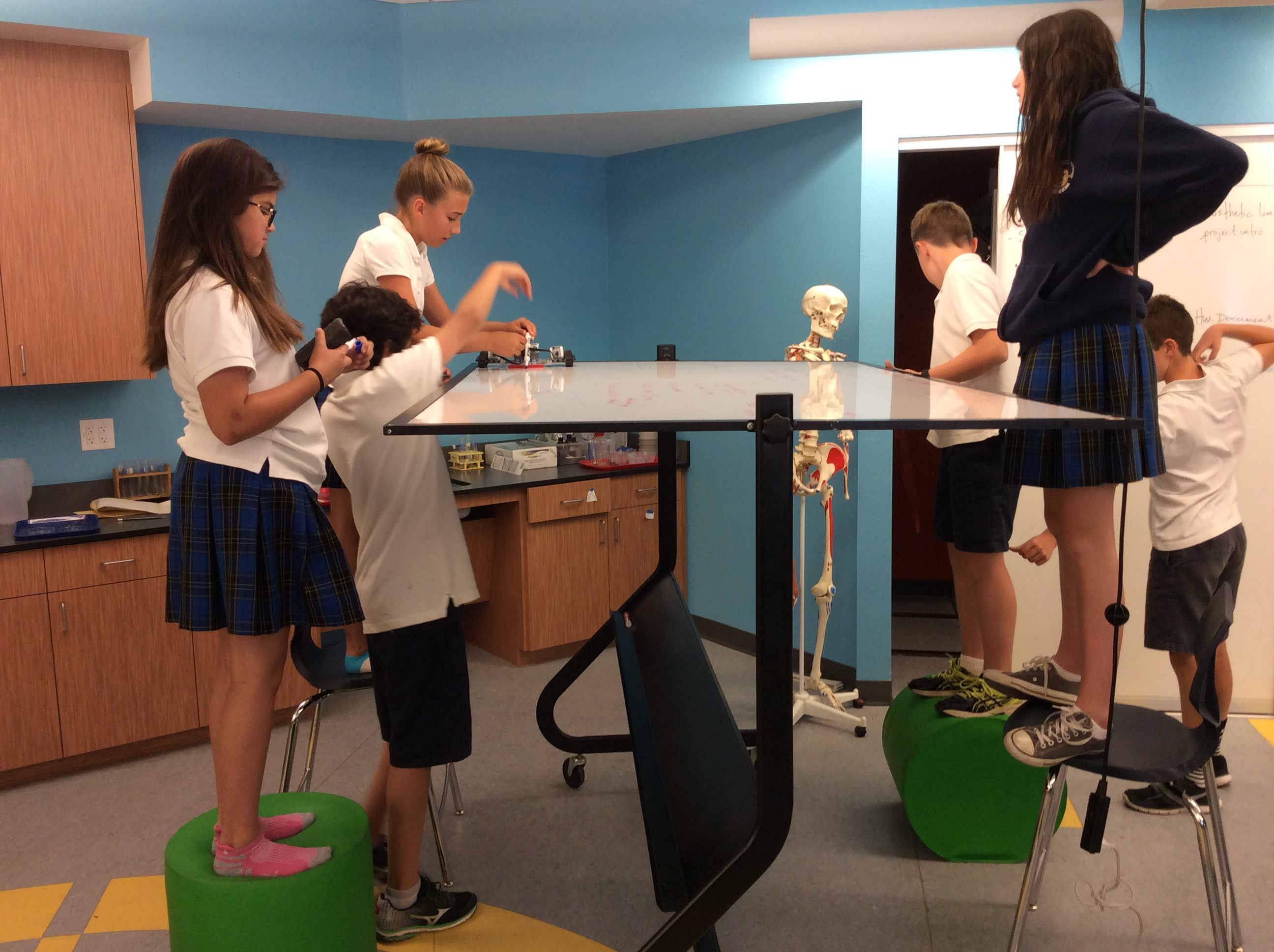 In a flexible room, a whiteboard morphs into a surface for a science lesson.