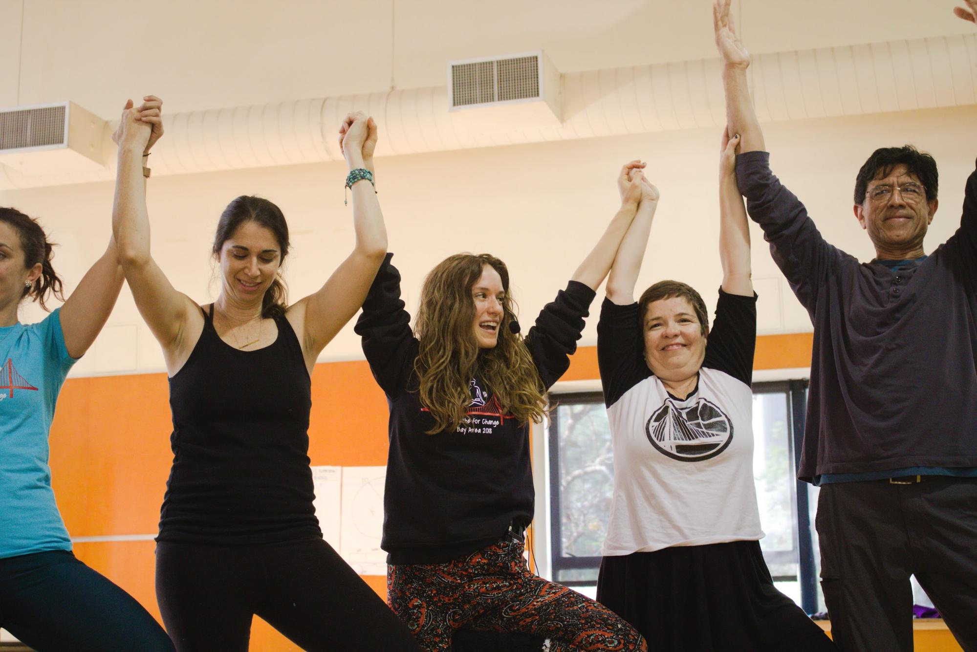The founder and CEO of Breathe For Change, Ilana Nankin (in black hoodie), joins hands with students. Photo Credit: Tina Nazerian