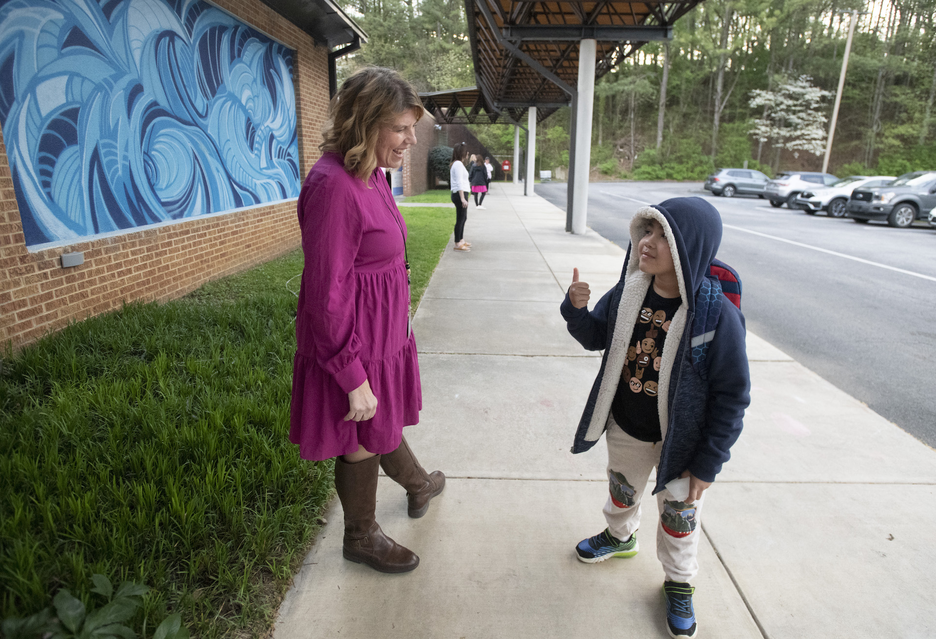 Principal and student near car line 
