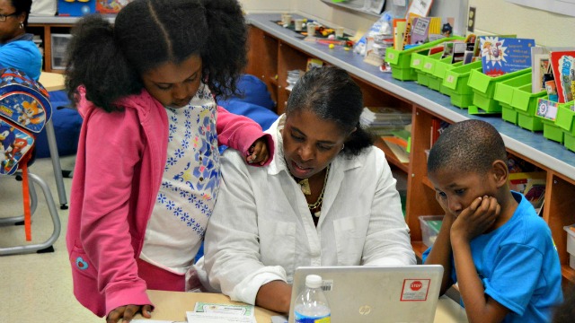 A family works together on a digital challenge during Night of Innovation (Baltimore County Public Schools)