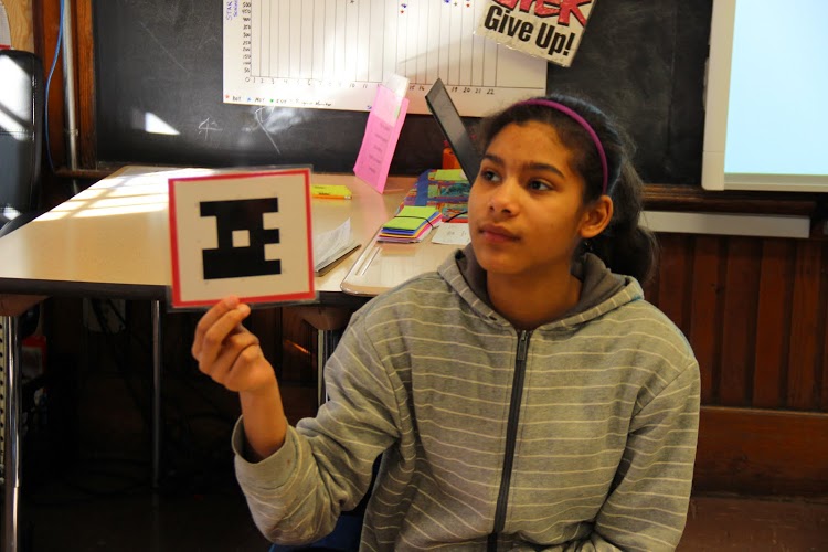 Students use Plickers to answer questions during "Checks for Understanding." (Shawn Rubin)