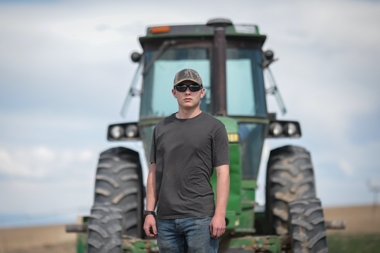 Spencer in front of a tractor