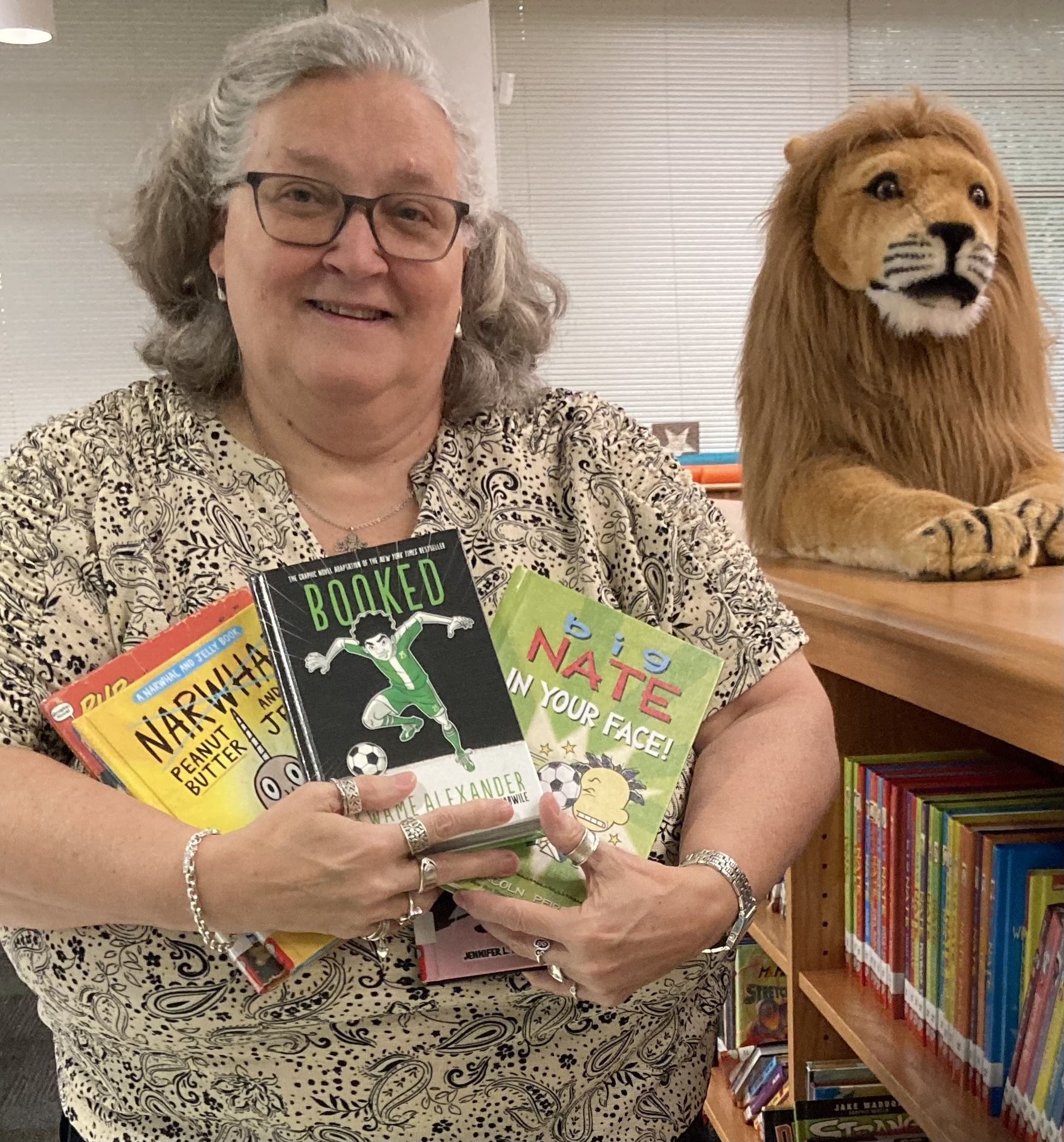 Cheryl Hensley poses in the library at Lockhart Elementary, where she was formerly a librarian and where she now volunteers monthly. She says that while the books have not been removed, they are not checked out to students. Photo courtesy of Hensley.