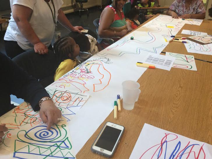 Pre-K students at A. Harry Moore excitedly watch an Ozobot respond to their drawing commands.