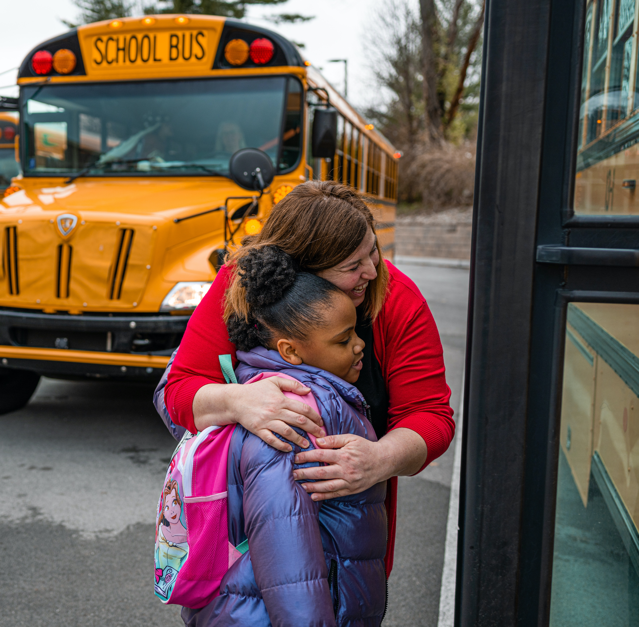 Cara Rothrock with a student outside of school. Photo by Jon Cherry for EdSurge.