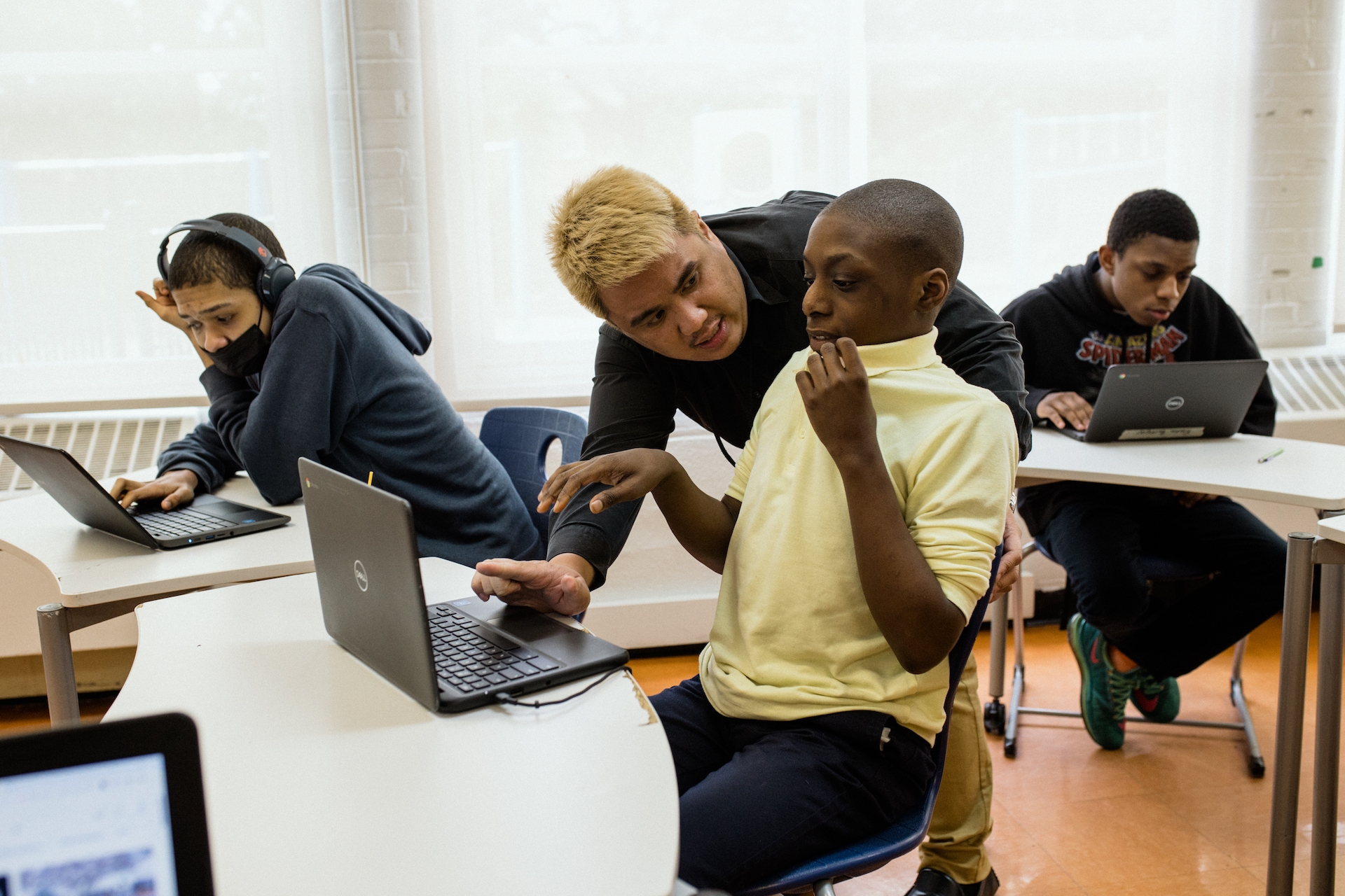 Cruz guides Noah Benjamin during a math class exercise.