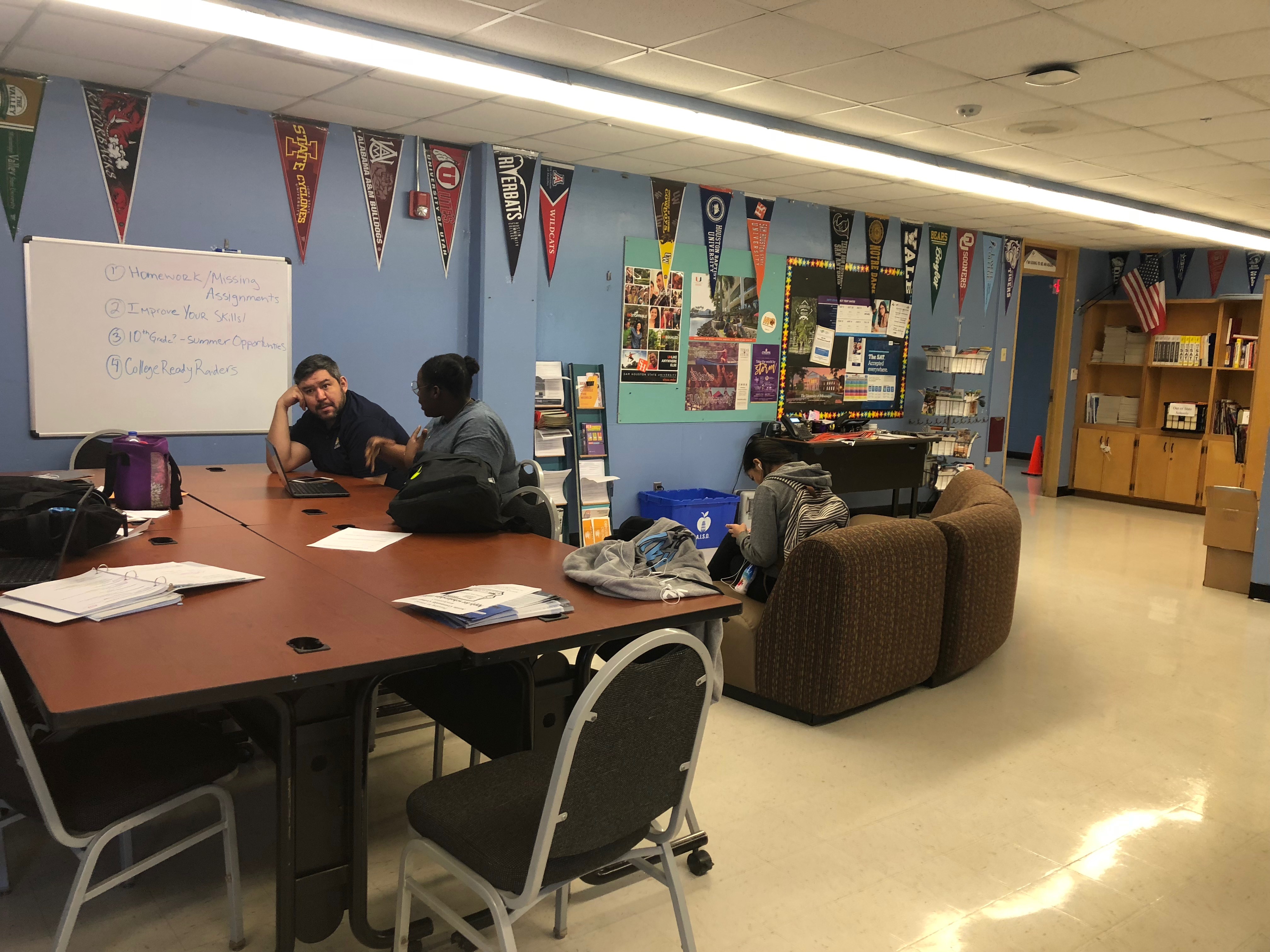 Volunteers working with students in the school's college and career center. Photo Credit: Jenny Abamu