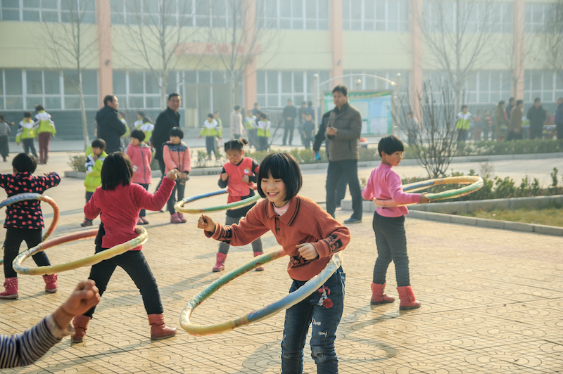 Children playing sports in school in Xingtai City, China. Photo by jianbing Lee / Shutterstock.