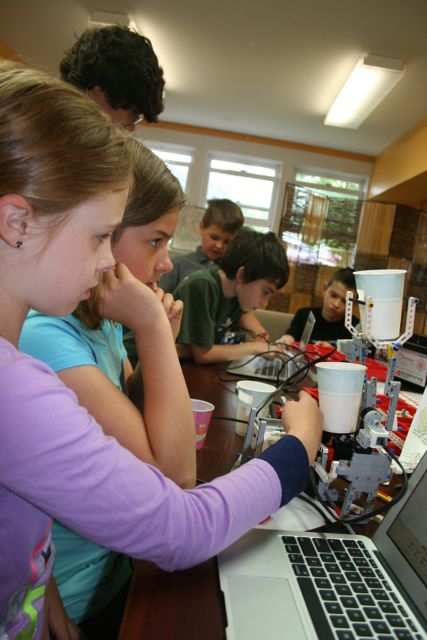 Figure 2: Students in a WMSI robotics camp are using MINDSTORMS to build systems for a robotic lemonade stand.