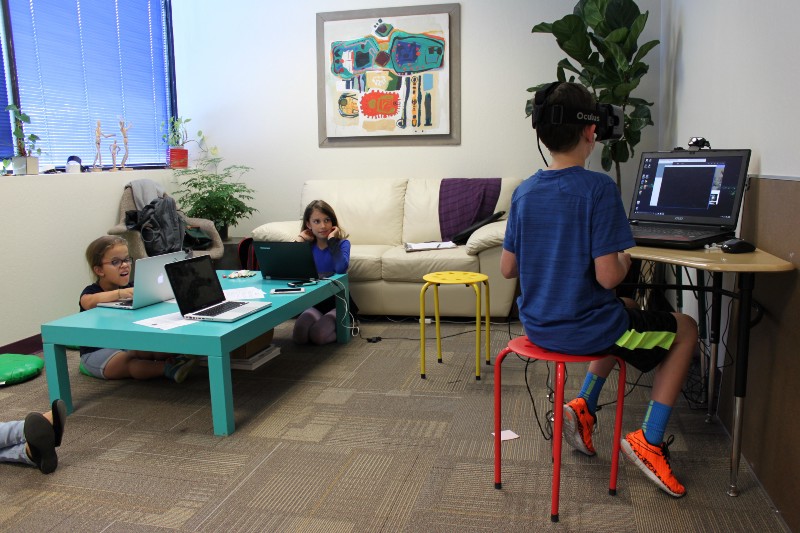 "Abby and Hannah filling out surveys as Ryan tries out the prototype." Photo courtesy Versatile.