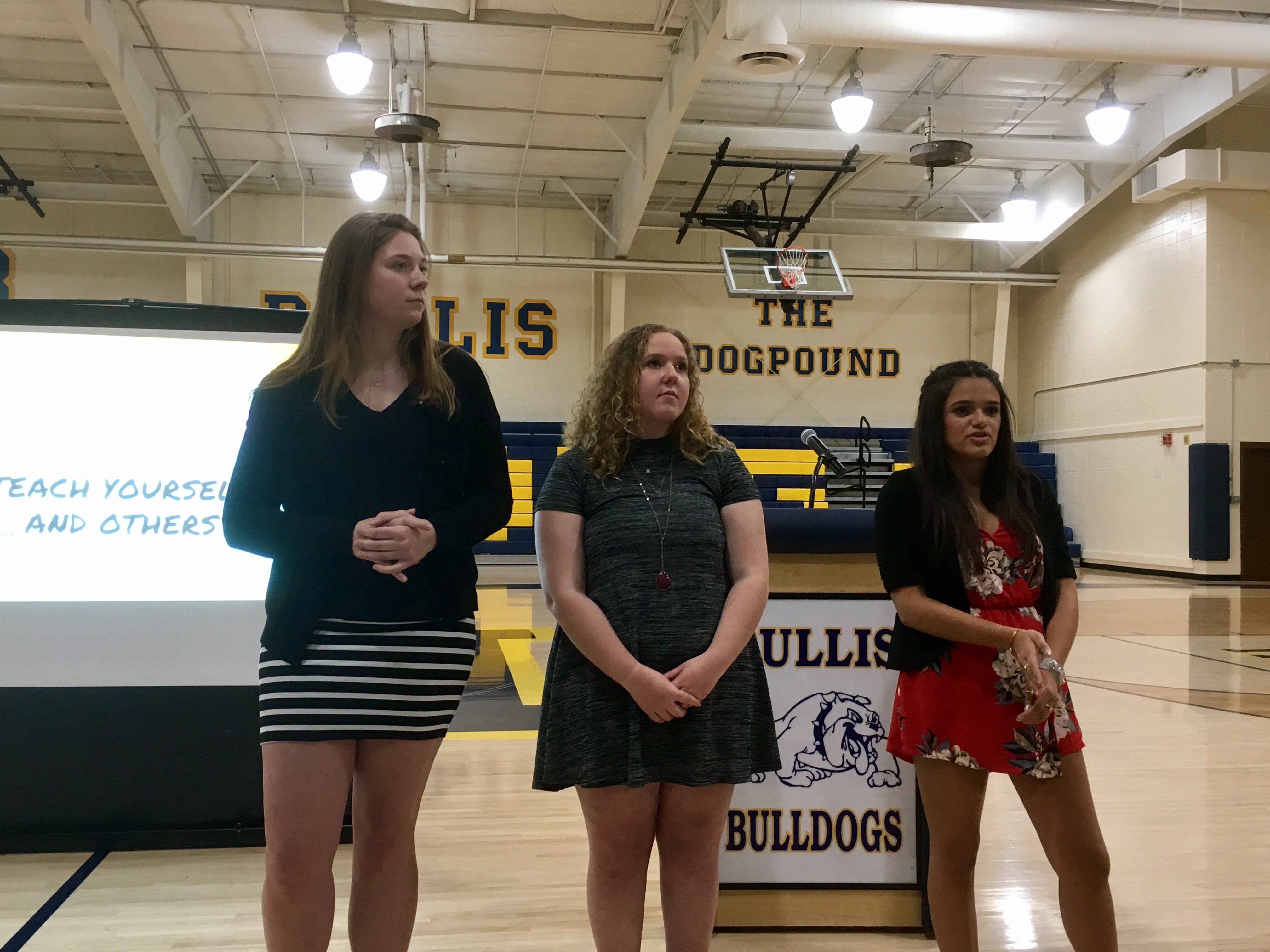 Nicole (right) and peers answer questions during the symposium.