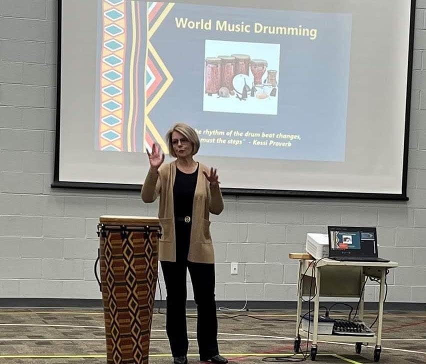 Julie Sherlock leads a drumming workshop for colleagues at her community mental health agency. "I still fill my teaching bucket," she says. Photo courtesy of Sherlock.