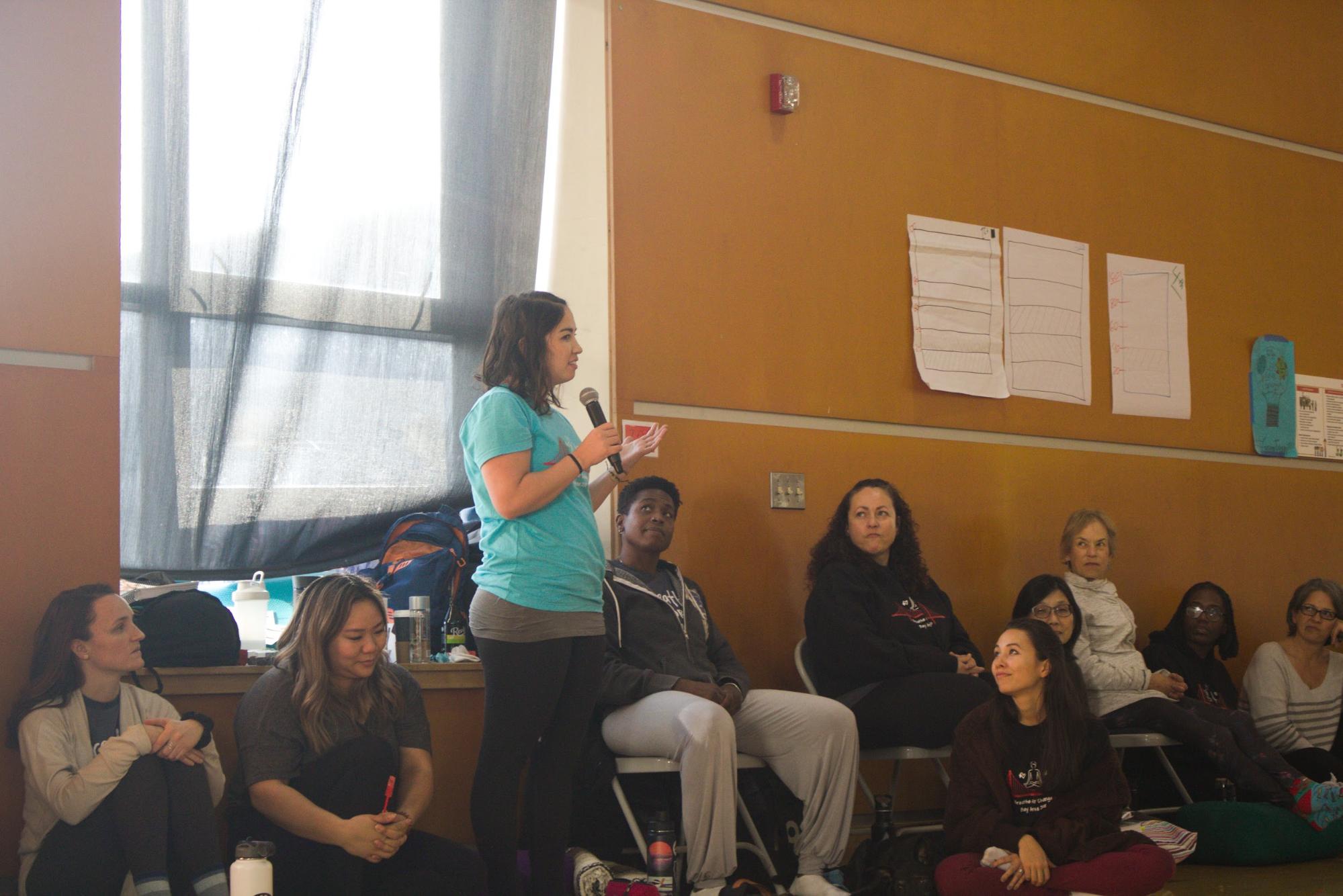 Breathe For Change student Desiree Choy (standing) shares some thoughts on her experience going through the program. Photo Credit: Tina Nazerian