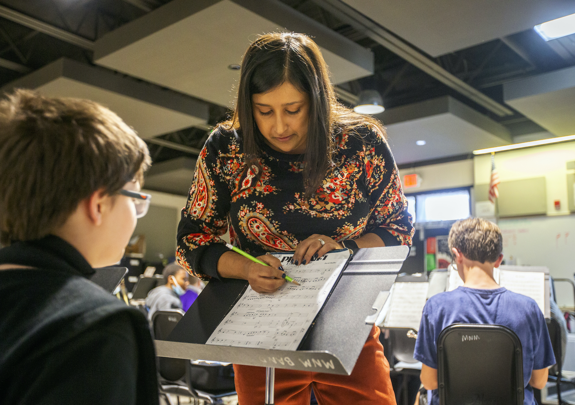 Swati Linder, a band teacher, reviews a piece of music with students in her class at Marrington Middle School of the Arts in Goose Creek, South Carolina. Photo by Gavin McIntyre for EdSurge.