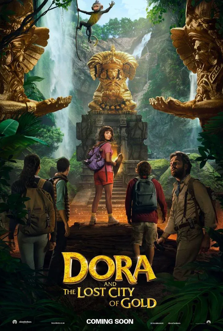 A group of explorers, led by a girl in a red outfit, stands before a large ancient golden statue in a lush jungle with waterfalls. The text reads “Dora and the Lost City of Gold.”.