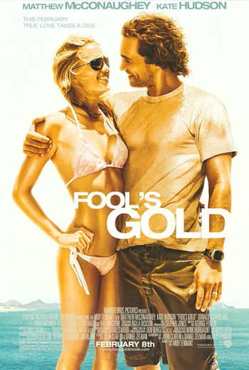 A man and woman in beachwear stand close together, smiling at each other, with an ocean backdrop. Text on the image reads "Fool's Gold" along with the actors' names and a release date.