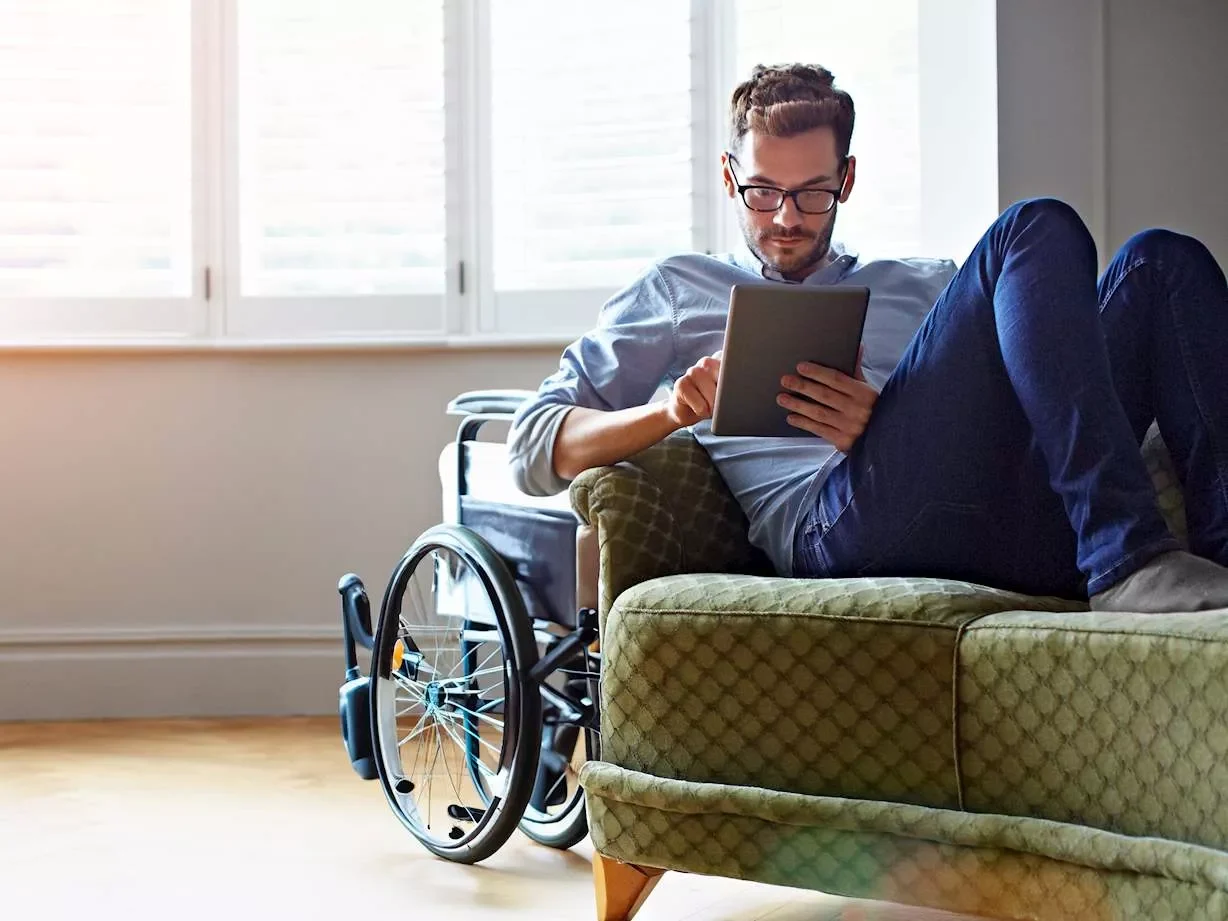 Man in living room using tablet to sign into online account