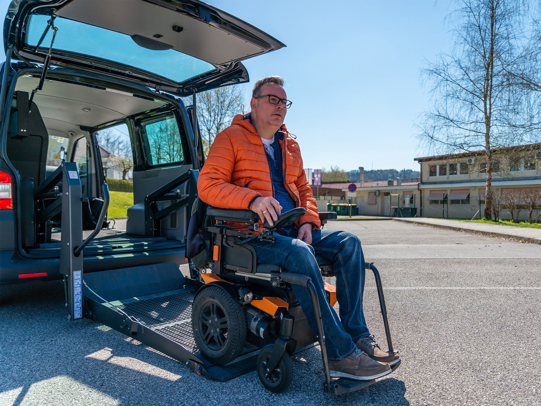 A man exiting a WAV using the rear lift