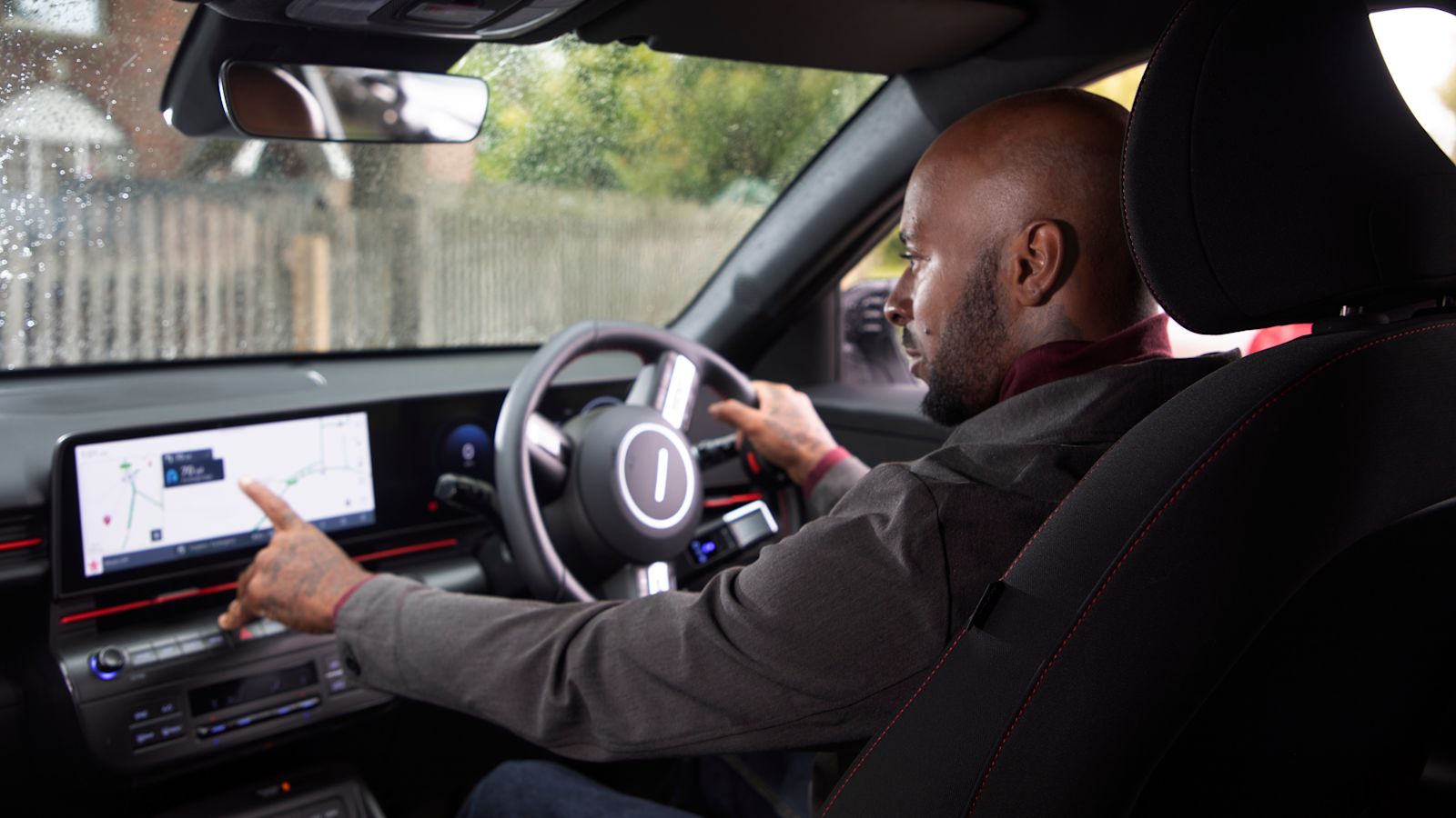 Man driving his car using the infotainment system screen