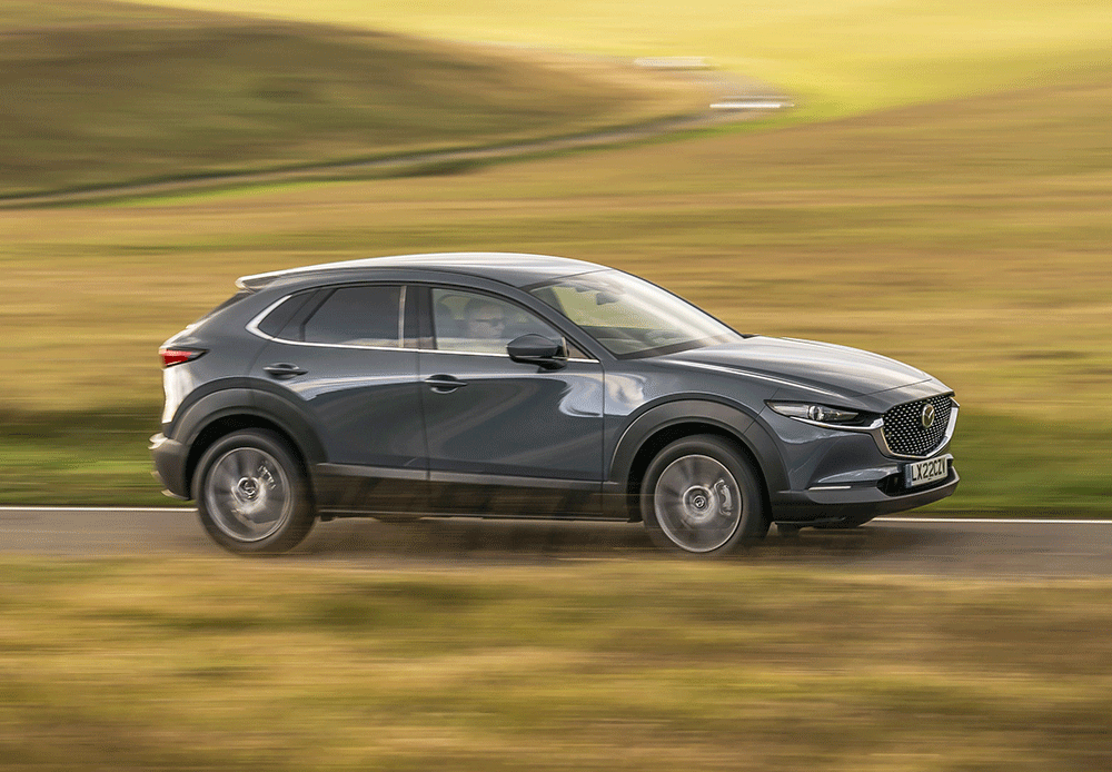 Dark grey Mazda with 5 doors