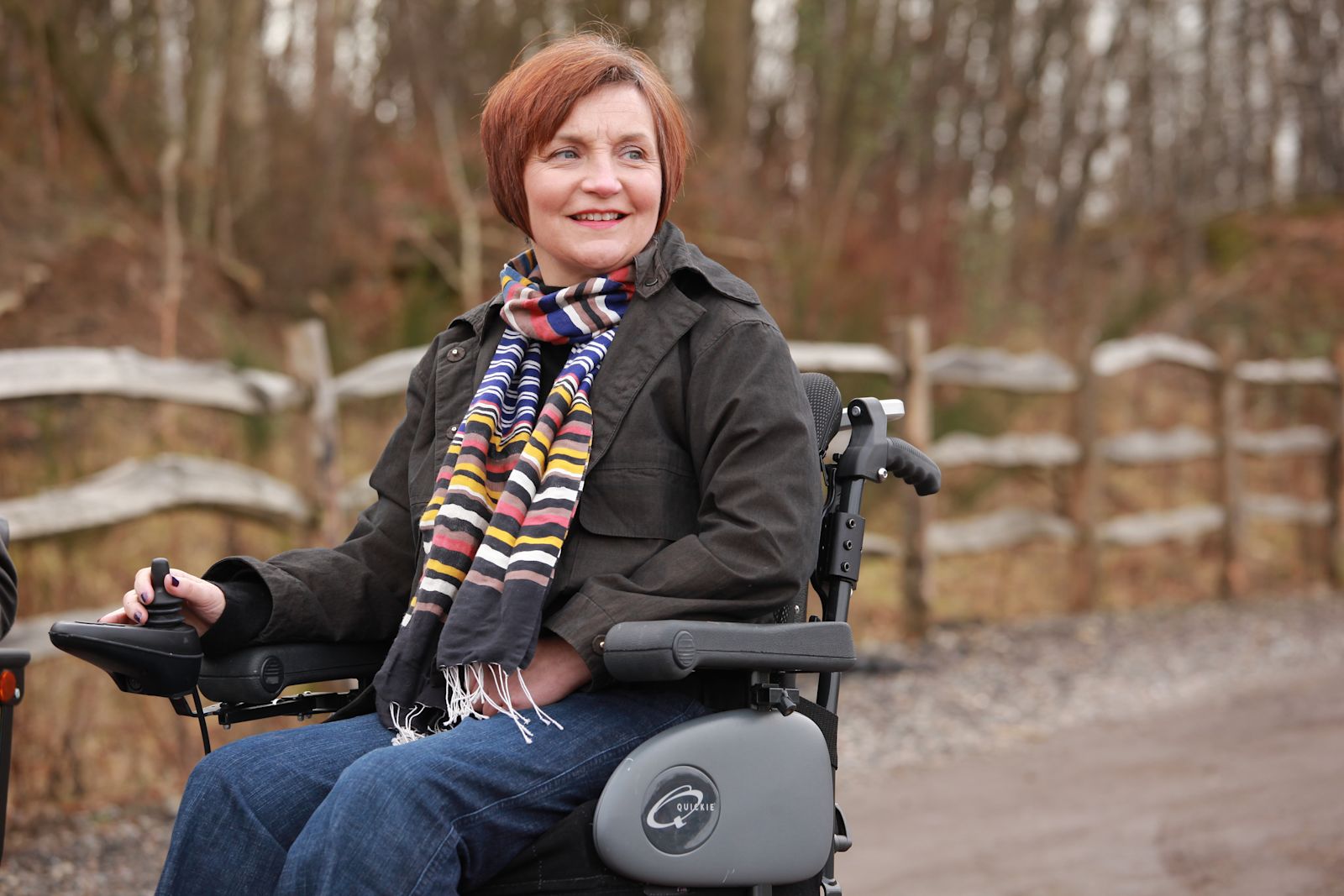 A woman in a powered wheelchair