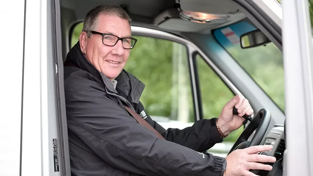A person at the steering wheel of a Drive From Wheelchair Accessible Vehicle