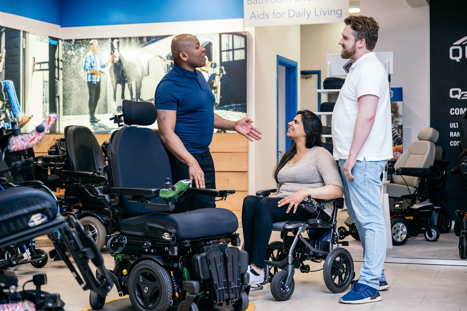 A couple trying a powered wheelchair in a showroom