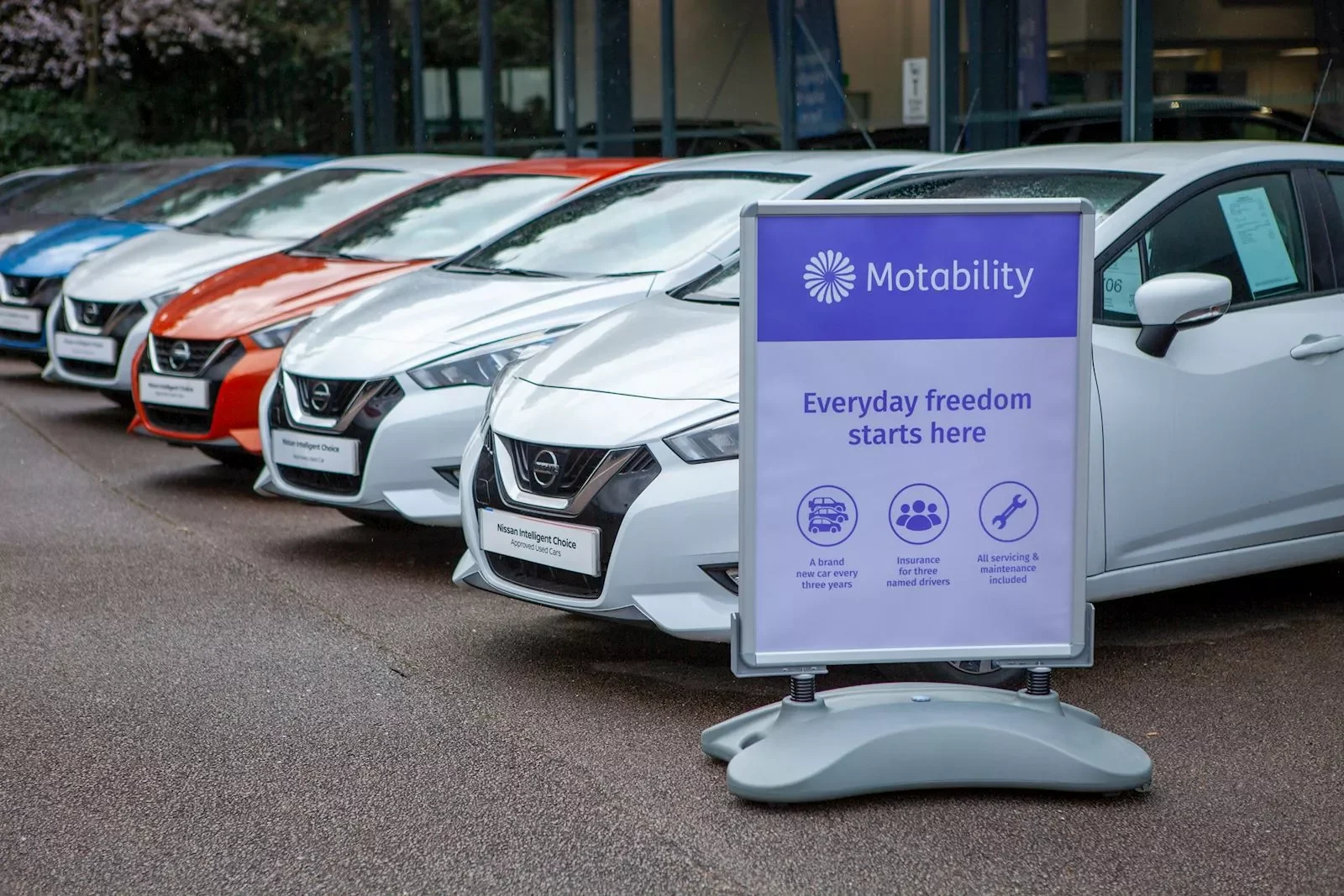 cars of different sizes and colours parked at a car dealership