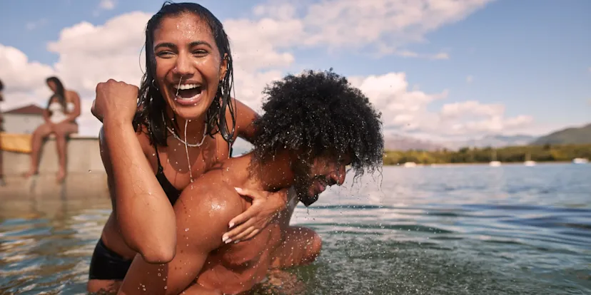 Couple in the sea laughing