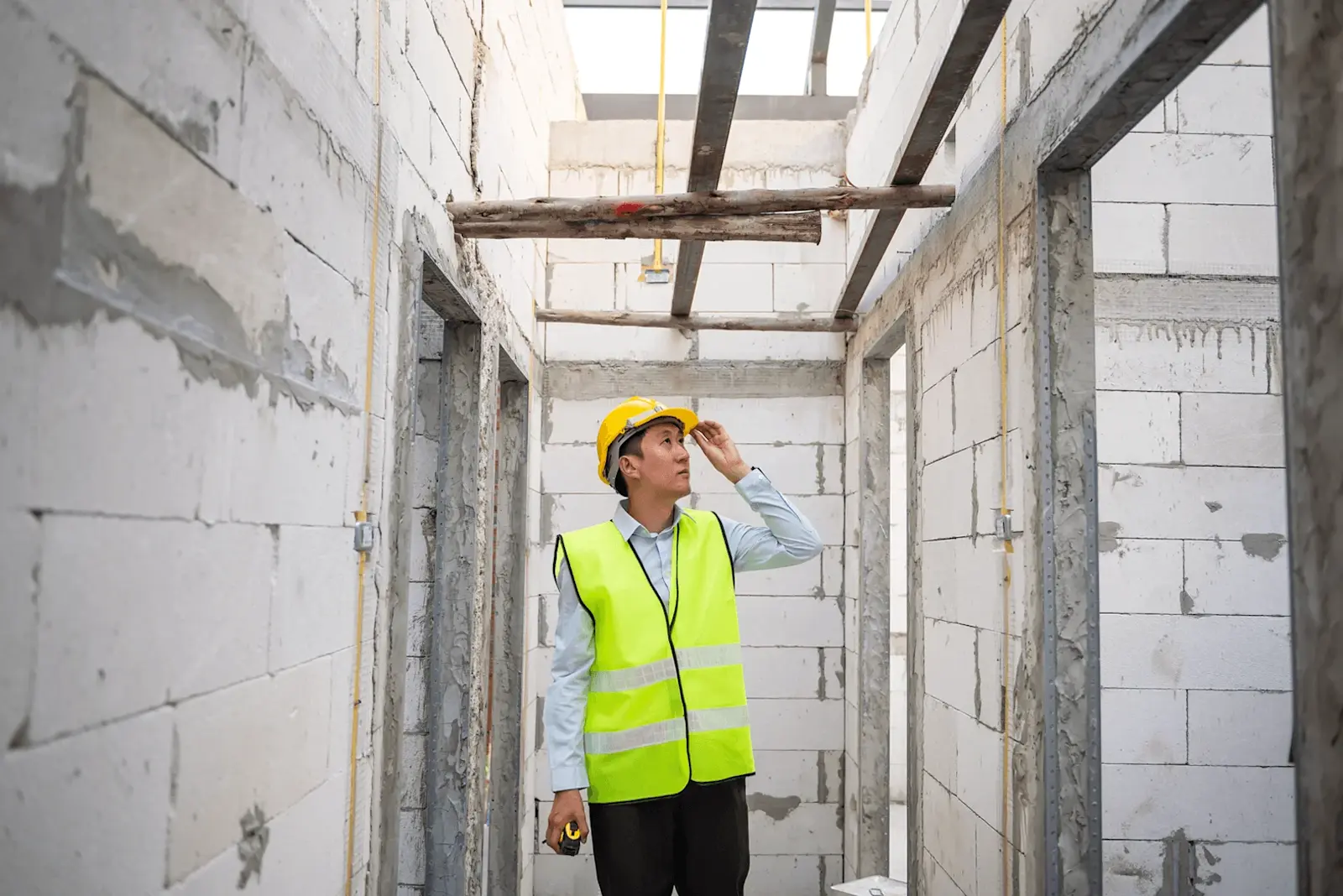 Foto: ein Mann begeht eine Baustelle und entdeckt mehrere Baumängel.