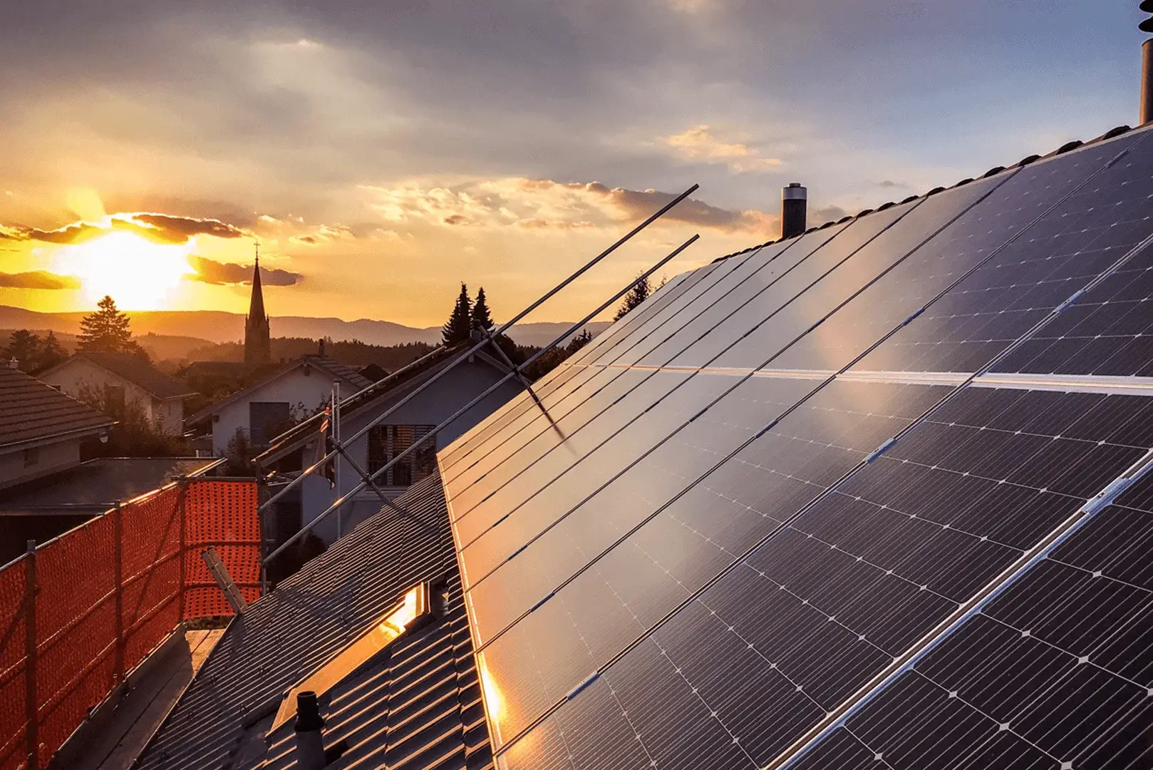 Foto: Ein Dach mit Photovoltaik Modulen bei Sonnenaufgang.