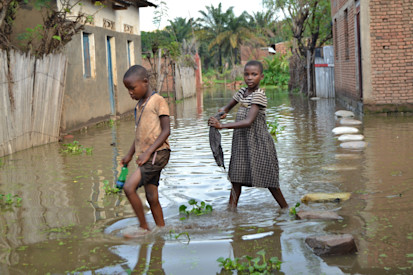 Two children playing in the stagnant flood waters caused by the rising waters of Lake Tanganyika in Bugarama commune, Rumonge province © A.Ndayiragije/OCHA 2021