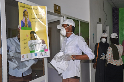 Community members in White Nile distributing COVID posters and sanitation products at a local hospital UNDP