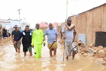People wadding through flooded streets in Bosaso . Photo: Bosaso mayor office