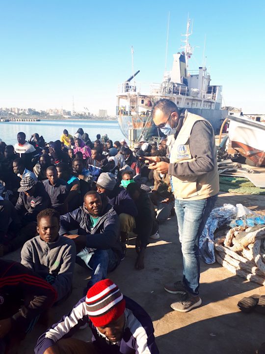 Assisting refugees at Tripoli naval base after their interception at sea and return to Libya. (UNHCR/Ahmed Ben Madi)