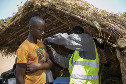   A young displaced man is being vaccinated against COVID-19 at a site for internally displaced people in Ippy. ©OCHA/Anita Cadonau, Ippy, Ouaka Prefecture, CAR, 2022.
