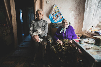 A family is sitting in their house close to the “contact line”. Photo: OCHA/Yevhen Maloletka