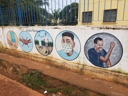 Measures to prevent the spread of COVID-19 painted on a public building in Bangui
