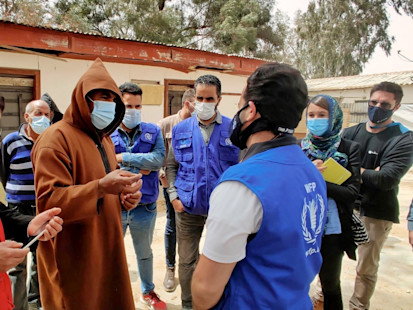 The humanitarian team visiting a displacement camp in Tarhouna and listening to the needs of displaced Tawerghans (OCHA/Ahmed Rih)