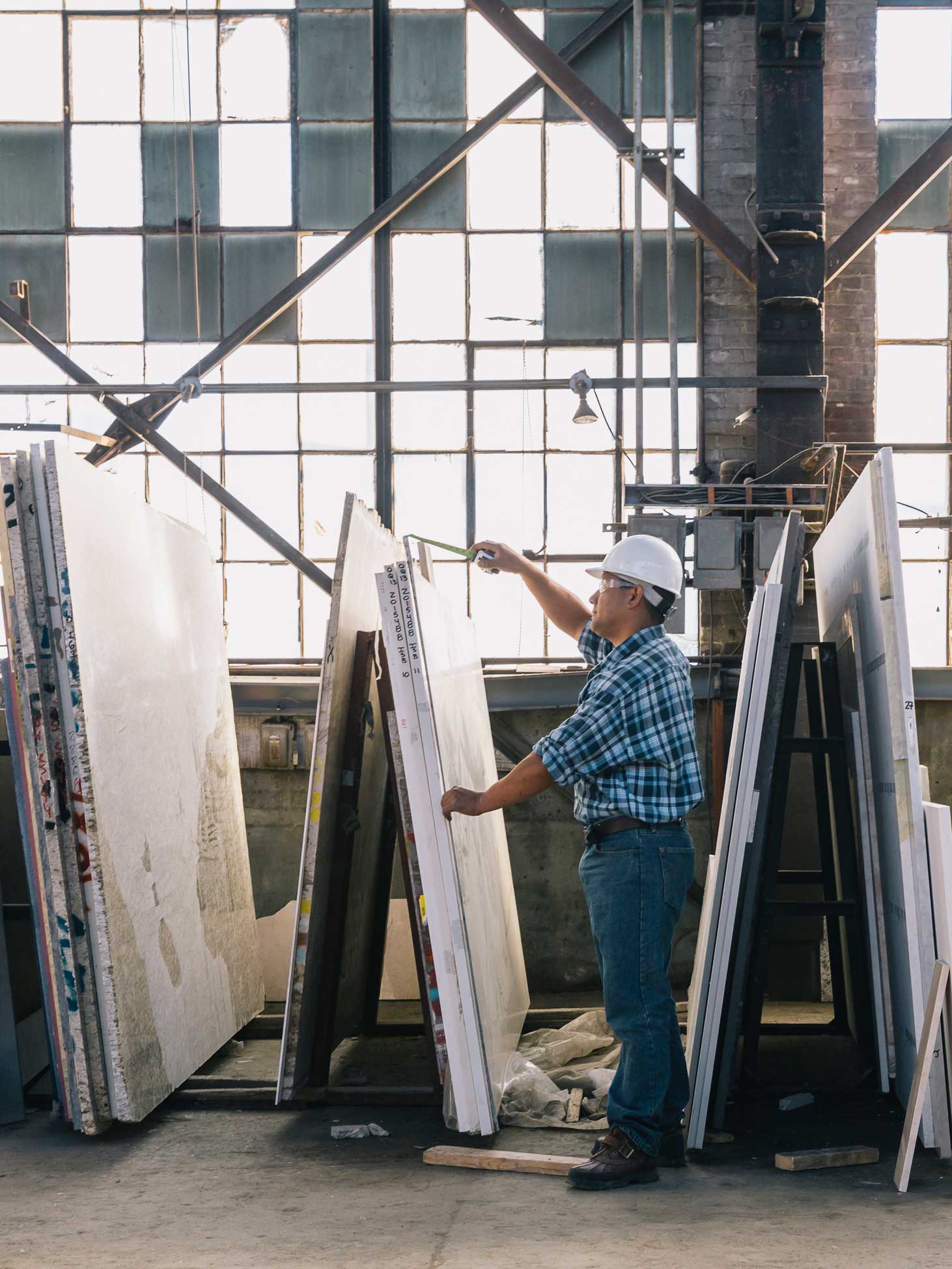 Man measuring a slab of granite