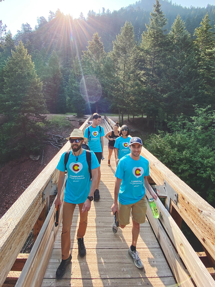 Five Elevations employees walking across a bridge at Eldorado Canyon State Park