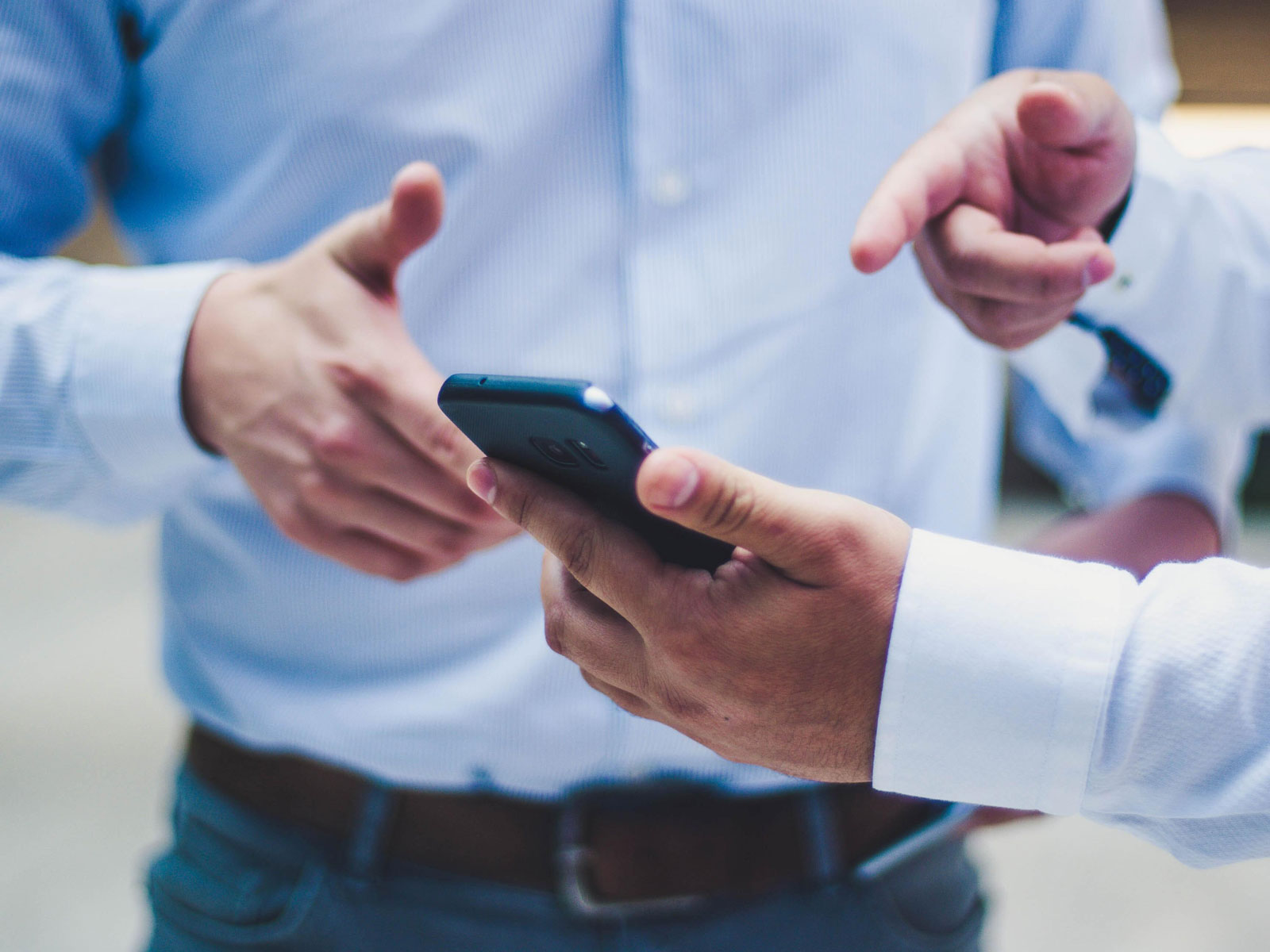 Business men looking at a phone