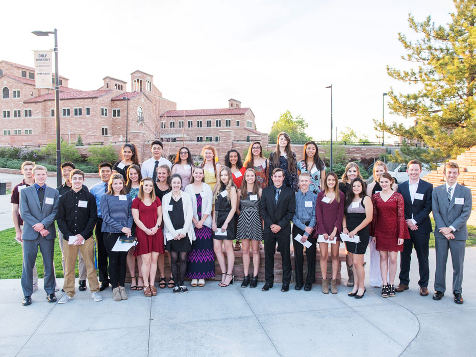 A large group of scholarship winners on a college campus