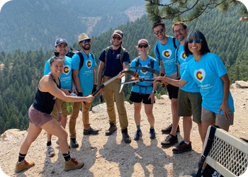A group of employees volunteering in a local mountain park