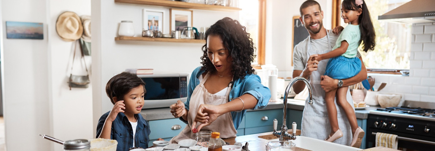 A young family spending quality time together in the kitchen at home.